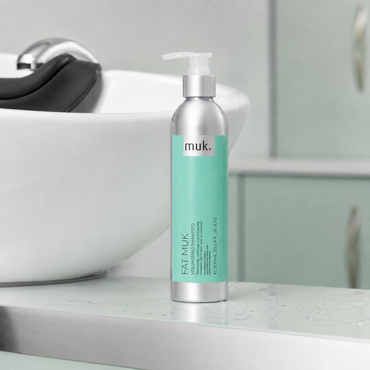 Fat muk Volumising Shampoo 300ml beside a salon wash basin