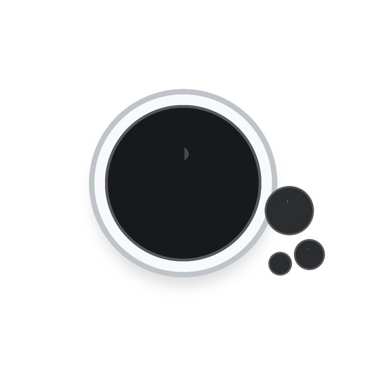 Glossy charcoal hair oil in a clear glass dish with dark oil droplets
