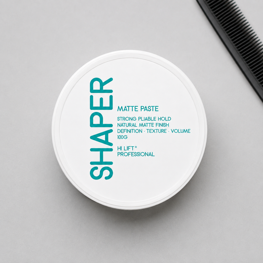Hi Lift Shaper Matte Paste 100g closed container in a salon flat lay