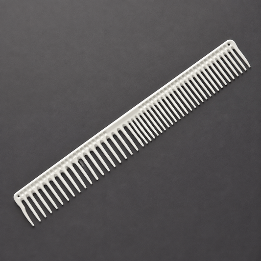 White 9-inch long round-tooth cutting comb shown diagonally on a charcoal surface