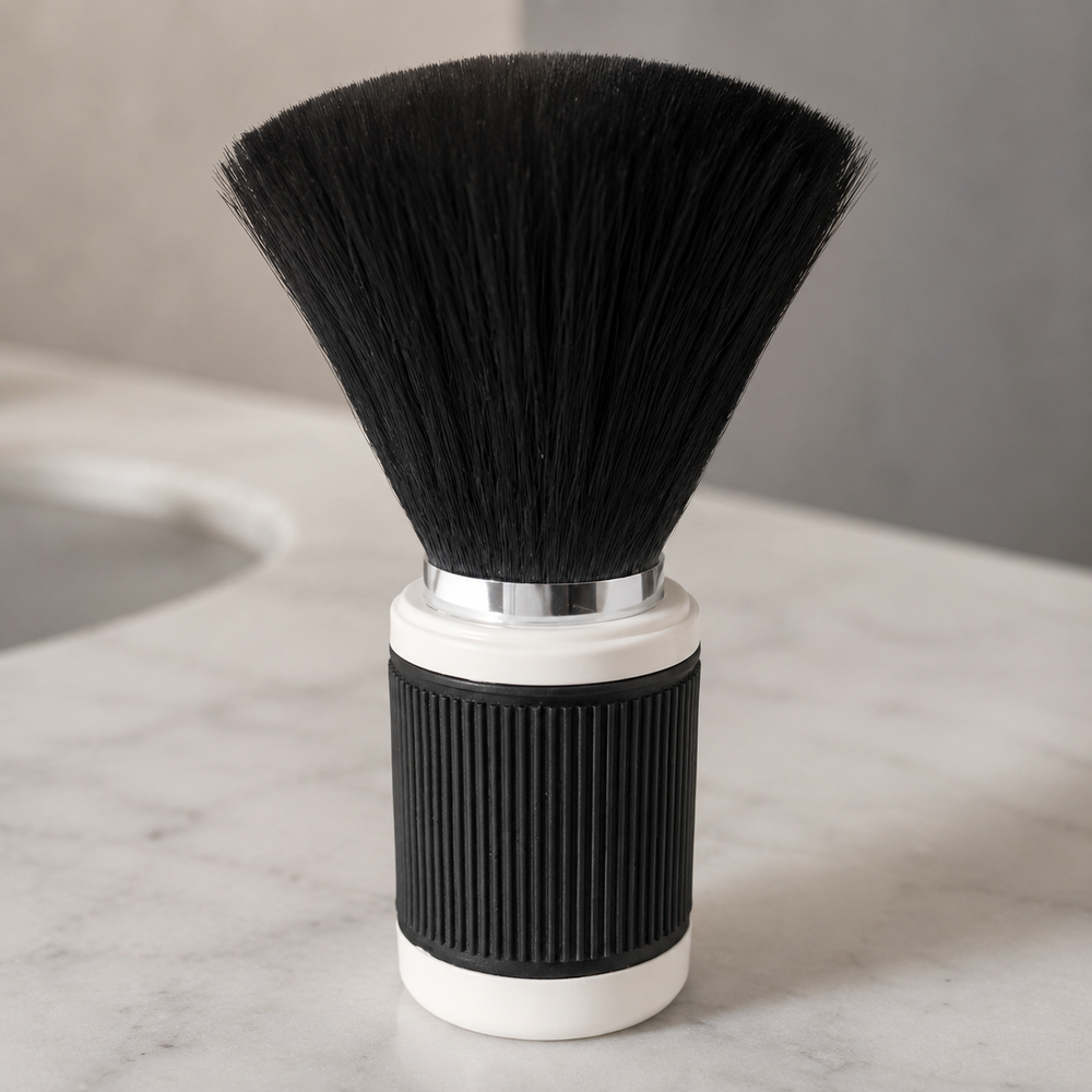 Close detail of dense black bristles and ribbed black-and-ivory neck brush handle