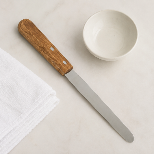 150mm metal spatula with wooden handle beside an empty salon wax bowl