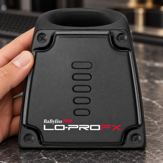 Black BaBylissPRO LoPROFX trimmer charging base held at its edge with the docking opening visible