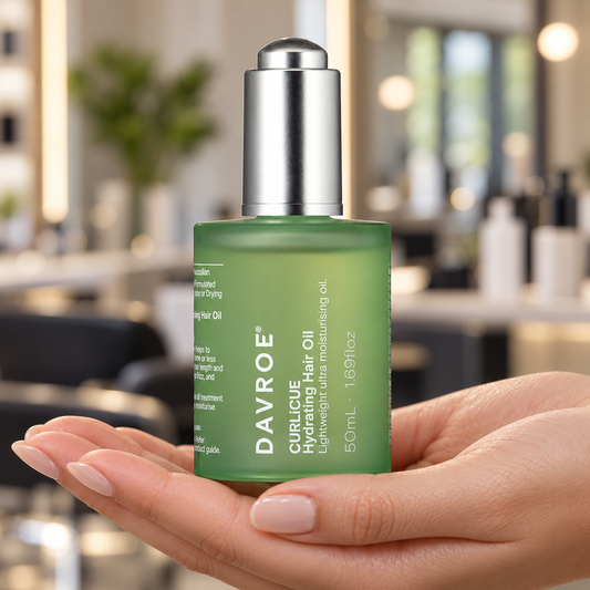 Davroe CURLiCUE Hydrating Hair Oil 50ml bottle held with its label visible.
