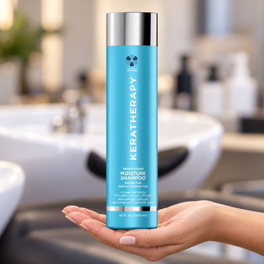 Keratherapy Moisture Shampoo 300ml supported in a stylist’s hand at a salon basin