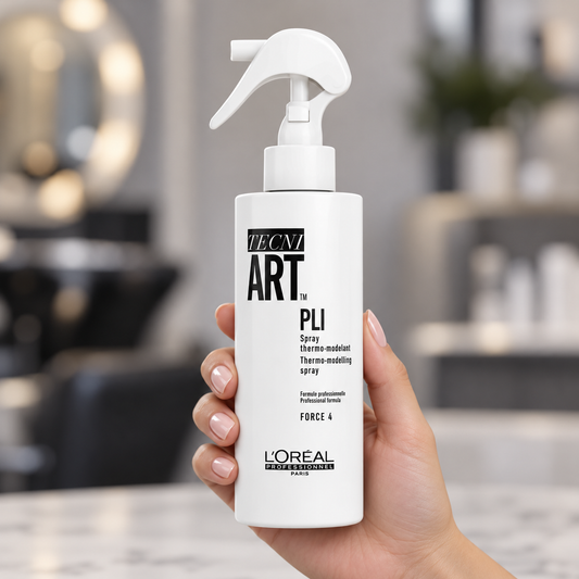 L'Oréal Professionnel Tecni.ART Pli spray bottle held upright, showing the trigger and front label