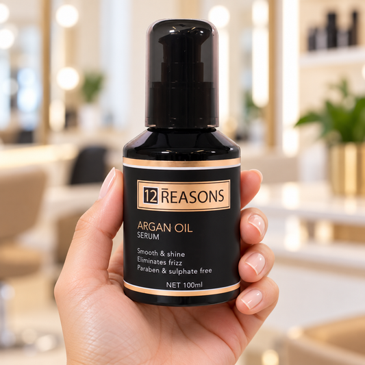 12 Reasons Argan Oil Serum 100ml held upright with its cap closed and front label visible.