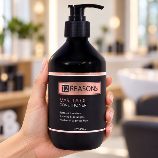12 Reasons Marula Oil Conditioner 400ml held with its pump and front label visible.