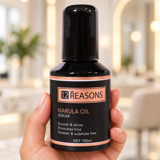 12 Reasons Marula Oil Serum 100ml held upright with the cap closed and front label visible.