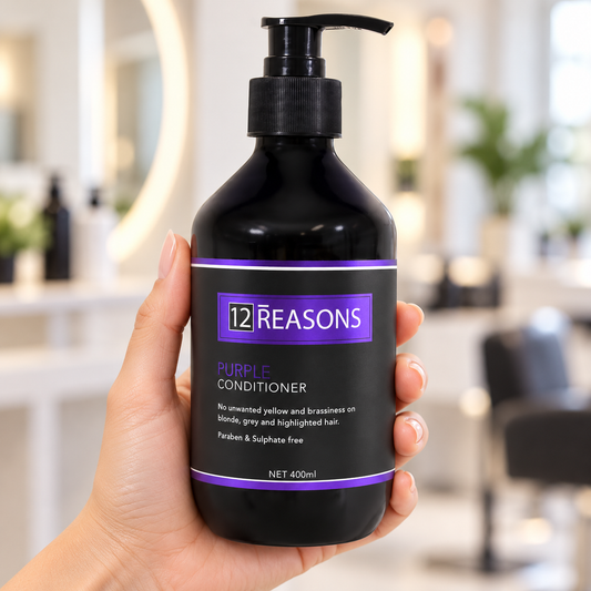 12 Reasons Purple Conditioner 400ml pump bottle held upright in a salon setting.