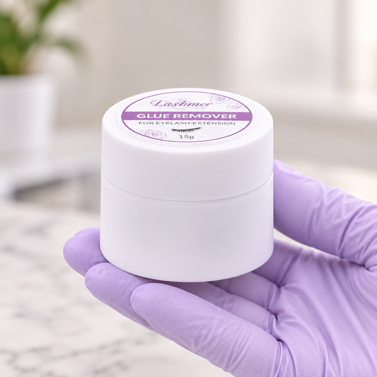 Closed Lashmer Glue Remover Cream 15g jar held in a gloved hand in a salon