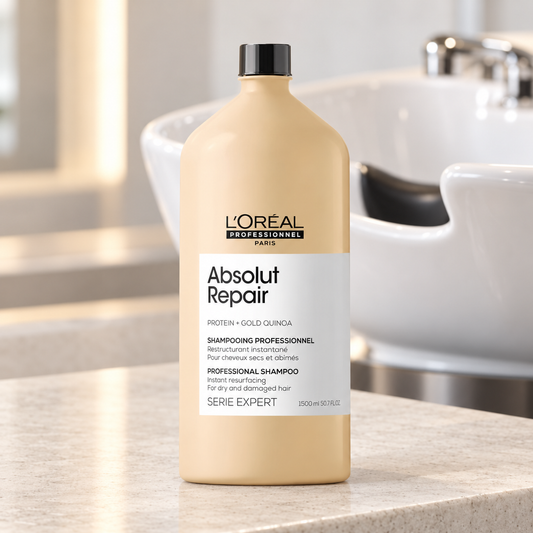 L'Oréal Professionnel Absolut Repair shampoo 1500ml standing beside a salon wash basin