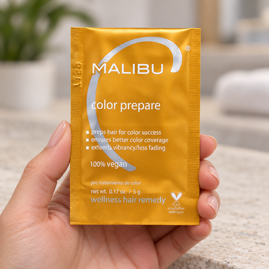 Malibu C Color Prepare Wellness Remedy 5g sachet held at the edges in a salon.