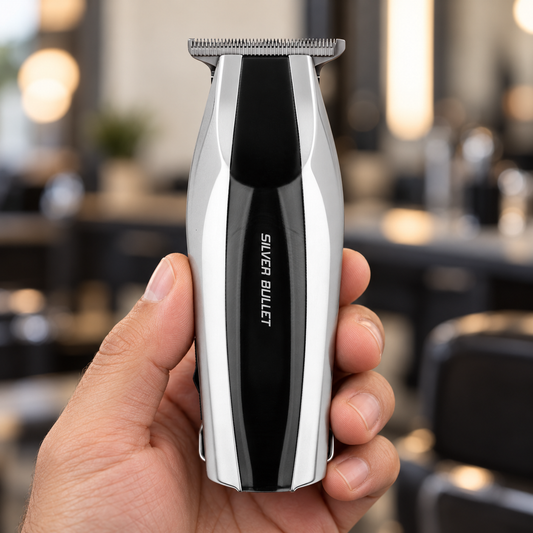 Silver Bullet Compact silver and black trimmer held upright in a salon, showing the blade and front casing.