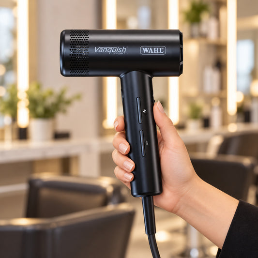 Wahl Vanquish Compact black dryer held by its handle, showing the controls