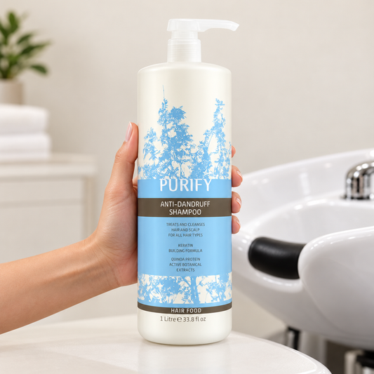 Natural Look Purify Anti-Dandruff Shampoo 1L bottle held beside a salon wash basin