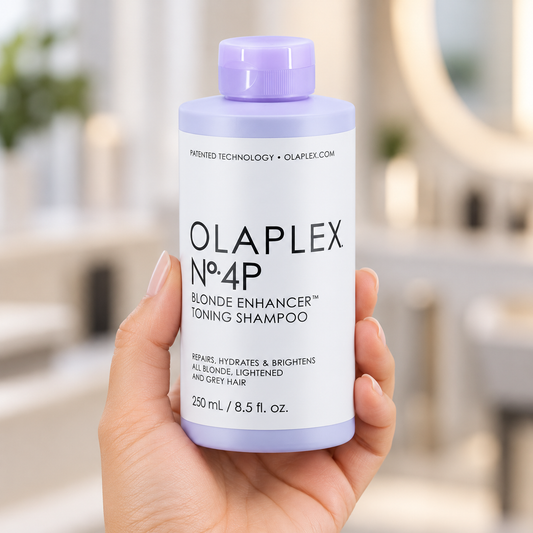 OLAPLEX No.4P Blonde Enhancer Toning Shampoo 250ml bottle held upright with its cap closed.
