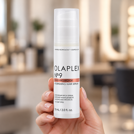 OLAPLEX No.9 Bond Protector Nourishing Hair Serum 90ml bottle held upright with its cap on.