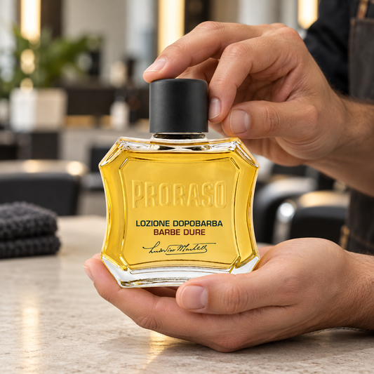 Proraso Lotion Nourishing 100ml held at a barber station, showing its original container.