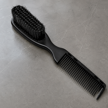 Close detail of black 2-in-1 fade brush bristles, fine comb teeth and pointed tail