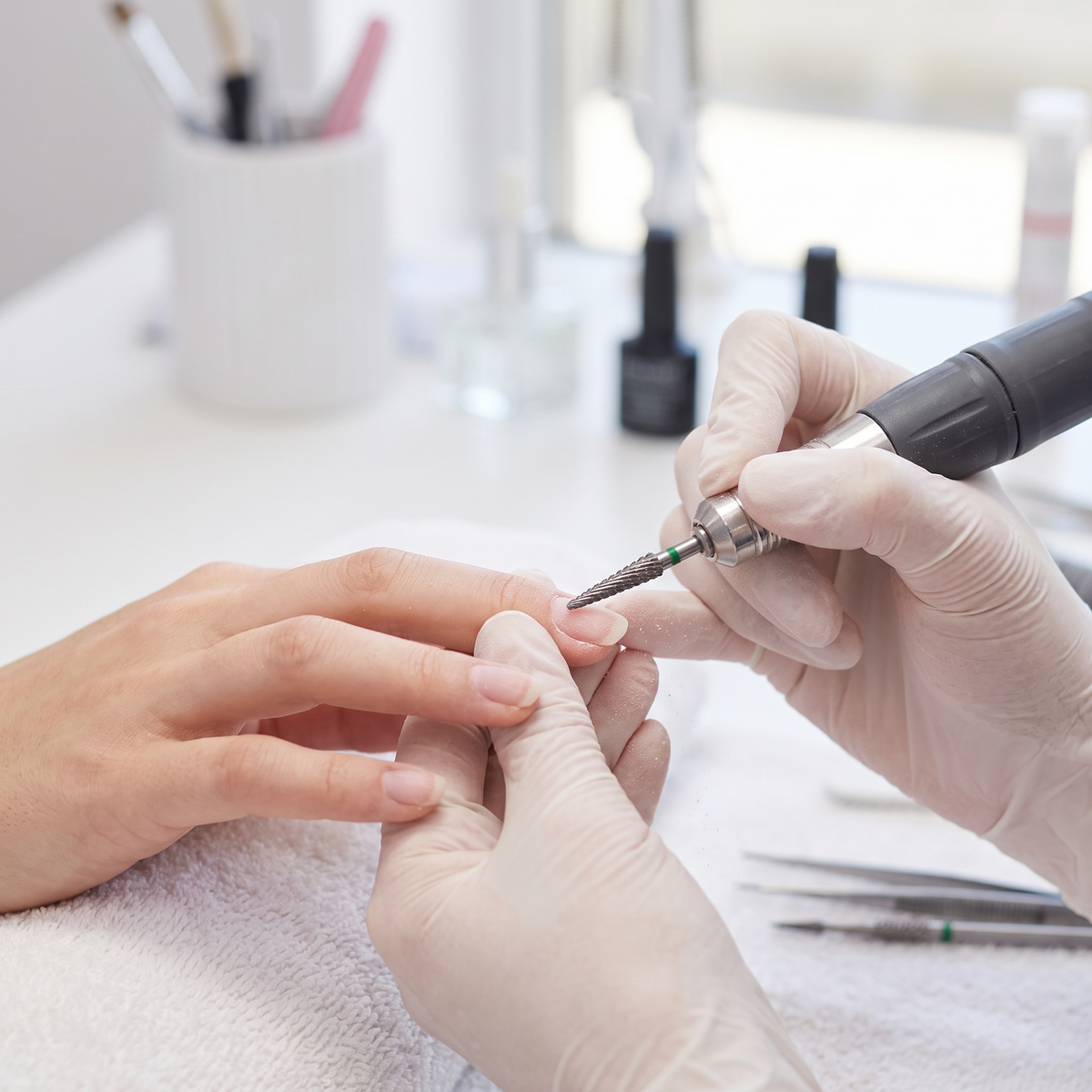 Nail technician using ACOS 3.1mm cone drill bit