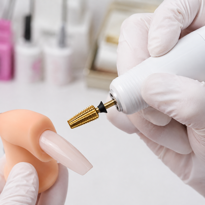 ACOS gold straight-cut drill bit fitted to an e-file above an artificial practice nail