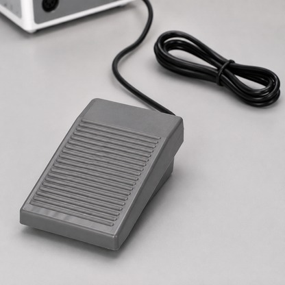 Grey ribbed foot pedal and cable included with the ACOS CUBE nail e-file
