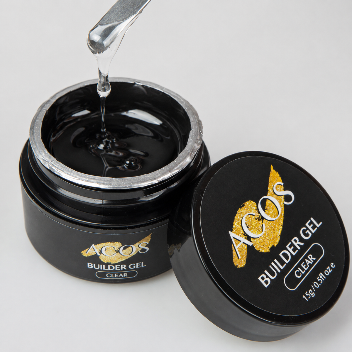 ACOS Builder Gel Clear open jar with transparent gel lifted on a metal spatula