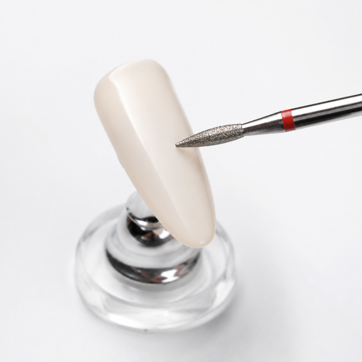 ACOS Bit002 flame drill bit demonstrated on a synthetic nail practice tip