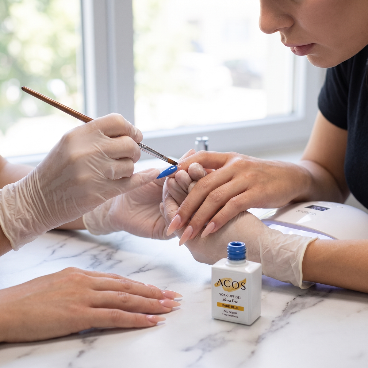 Nail technician applying ACOS Dark Blue gel