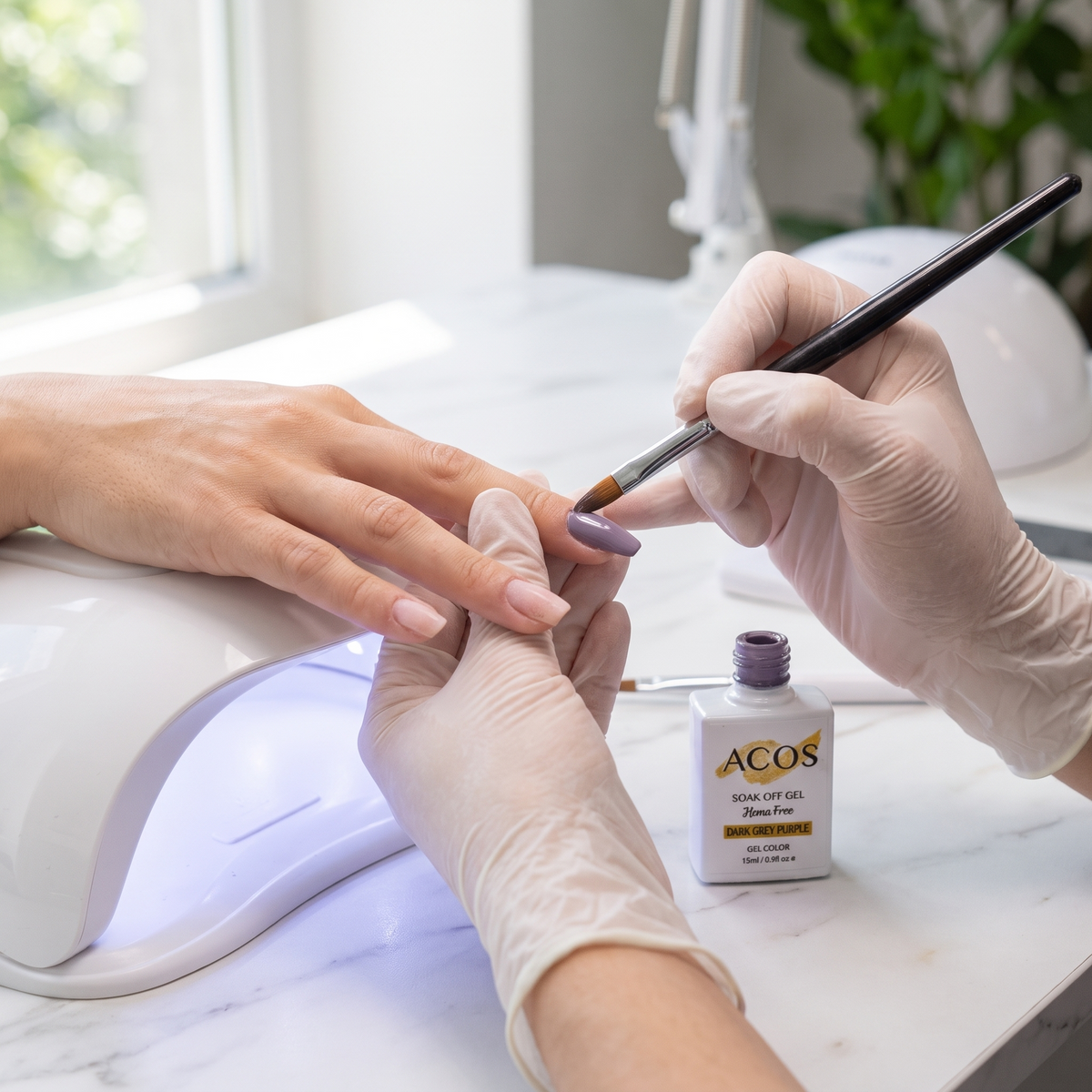 Nail technician applying ACOS Dark Grey Purple gel