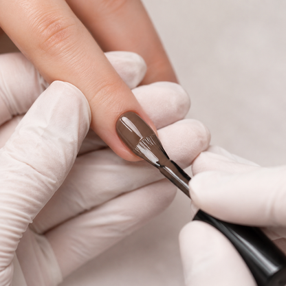 Professional applying ACOS Natural Brown 013 gel colour to a prepared fingernail