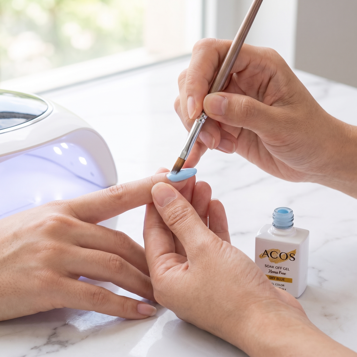 Nail technician applying ACOS Sky Blue gel