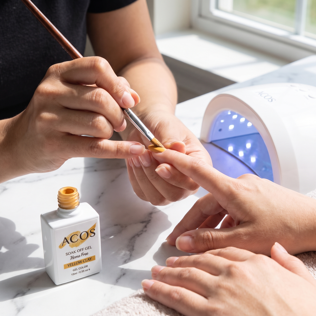 Nail technician applying ACOS Yellow Clay gel