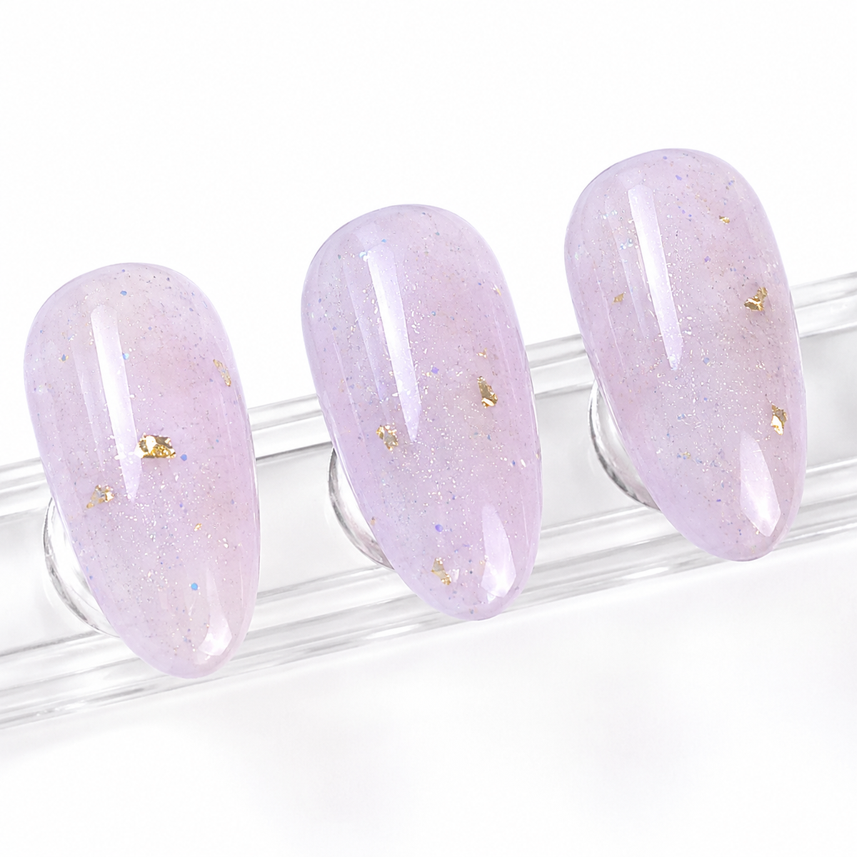 Three cured ACOS Glitter Purple 089 artificial nail swatches on a clear display