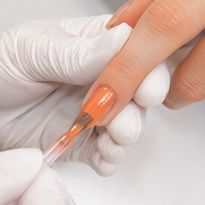 Professional application of ACOS Mature Orange 067 gel colour to a natural nail