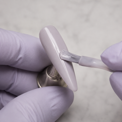 Professional application of ACOS HF077 Milky Purple Clay gel to an artificial nail tip