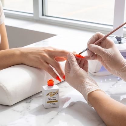 Nail technician applying ACOS Magic Beauty Bright Orange gel