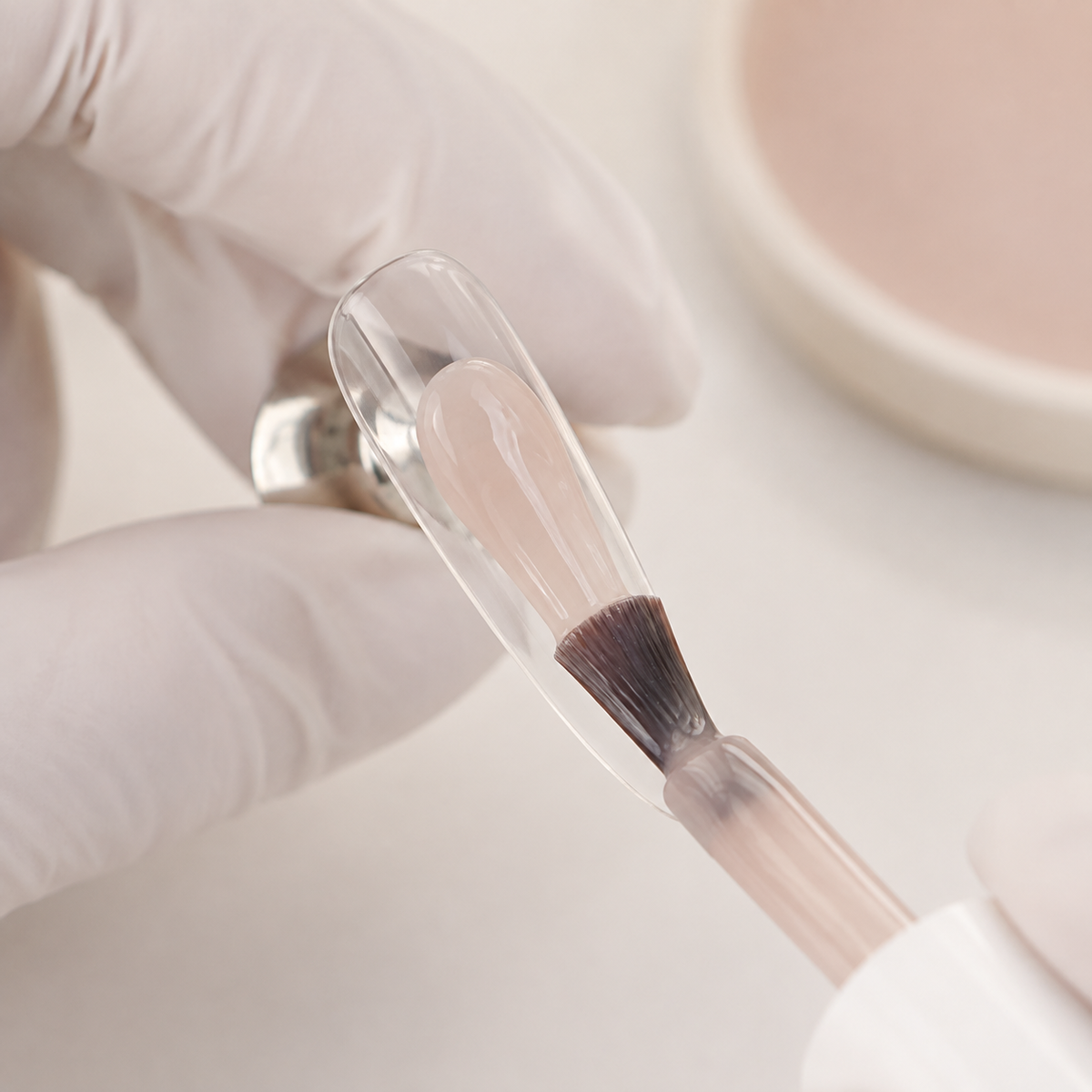 Nail professional applying ACOS Transparent Brown 073 to a clear practice tip