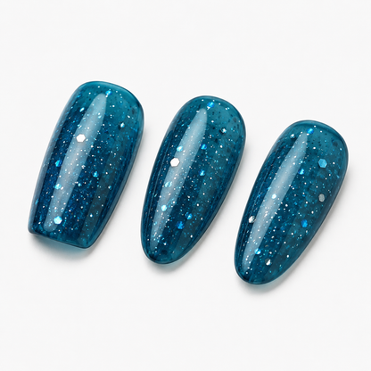 ACOS Glossy Blue 101 shown on three transparent blue glitter nail swatch tips