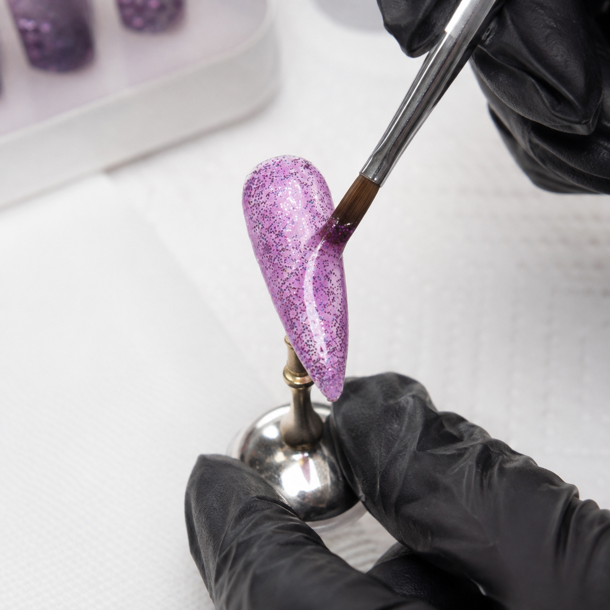 Professional applying ACOS shade 096 glossy glitter purple gel to a nail tip