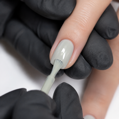 Professional application of ACOS Gel069 light green-grey gel colour to a prepared nail