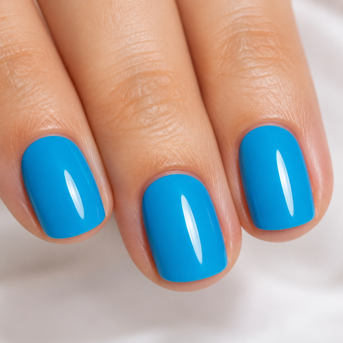 Finished manicure detail in glossy Light Peacock Blue 029 gel polish