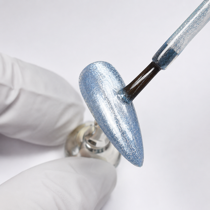 Professional applying ACOS Slim Star 086 blue-silver shimmer gel to a nail tip