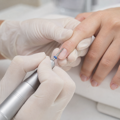 Nail technician using an ACOS medium round drill bit during a manicure