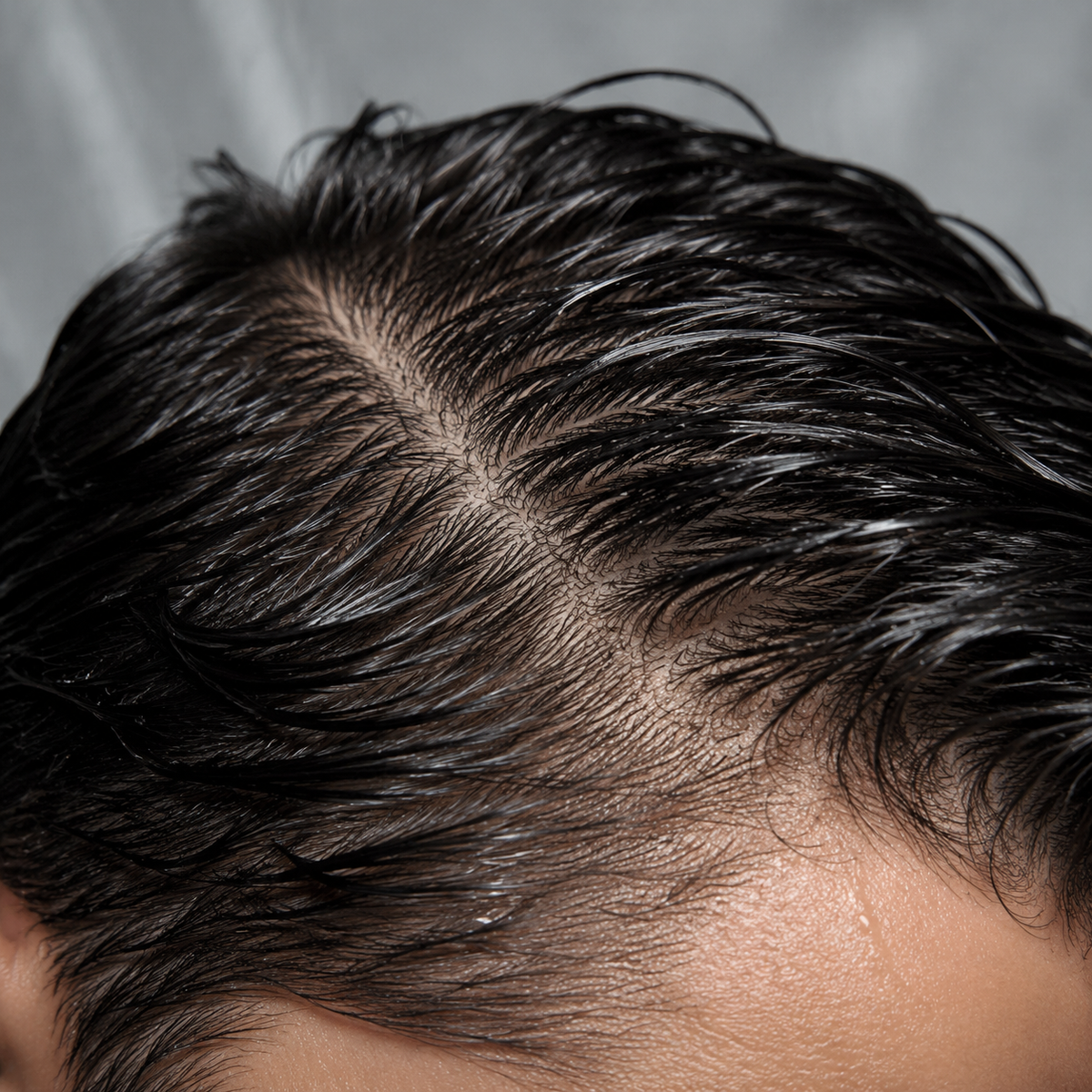 Close detail of clean-looking wet hair and scalp after shampooing