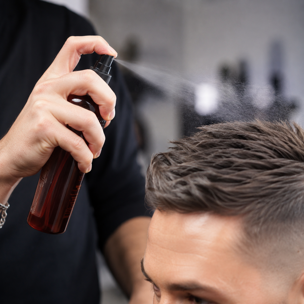 Stylist applying American Crew Grooming Spray 250ml to short hair