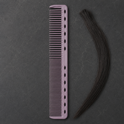 Purple cutting comb tooth detail beside sectioned dark hair
