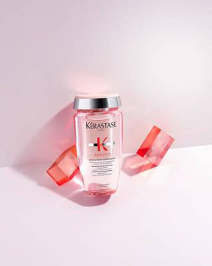 Kérastase Genesis Bain Hydra-Fortifiant 250ml bottle among pink acrylic blocks