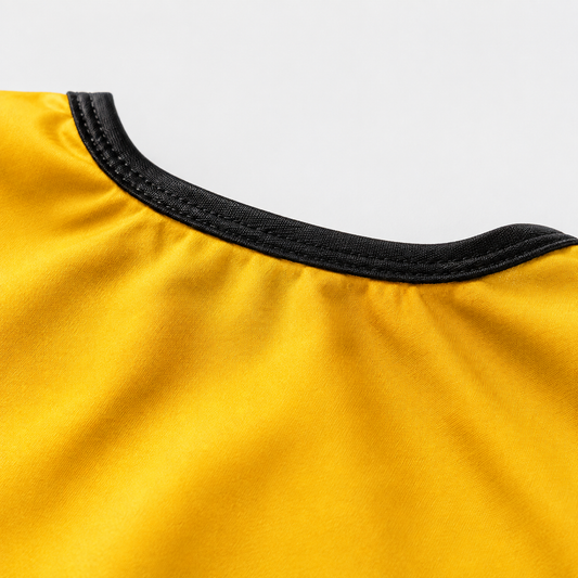 Legend Kobe barber cape yellow fabric and black neckline detail